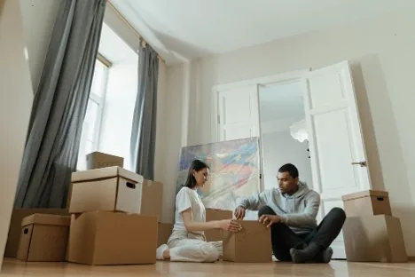 Couple unpacking moving boxes