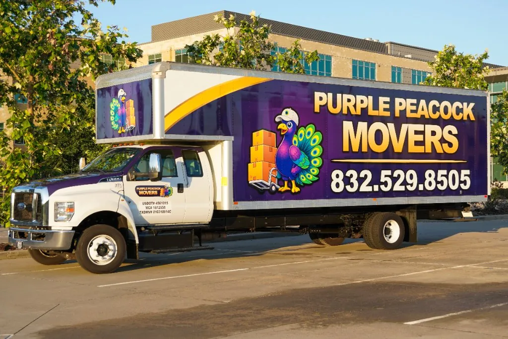 Purple Peacock Movers truck with the peacock mascot and 832.529.8505 on the side
