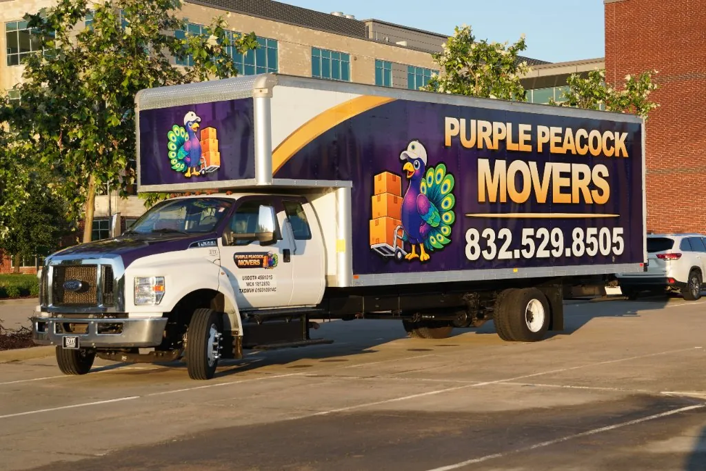 The Purple Peacock Movers truck with the company's peacock mascot and phone number